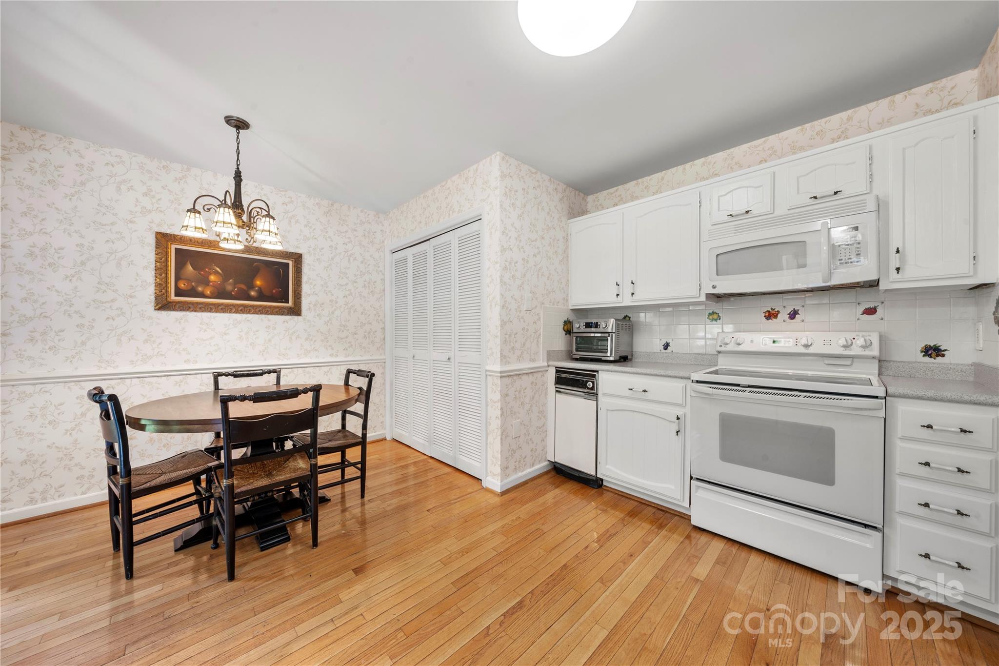 8928 St Croix Lane Charlotte, NC 28277 - Photo 14 of 37 a kitchen with granite countertop white cabinets and white appliances