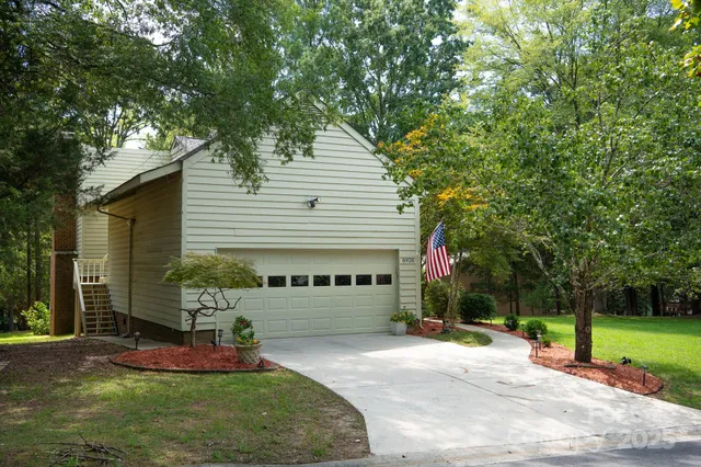 a view of a house with backyard and sitting area