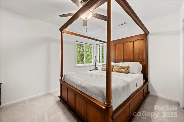 a bed room with a bed and a window