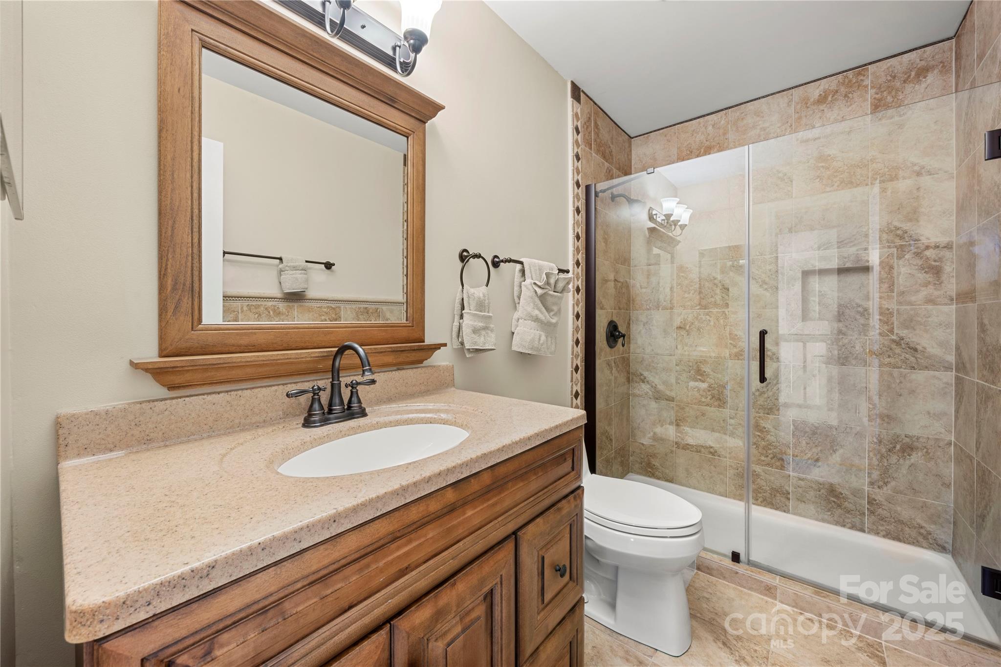 8928 St Croix Lane Charlotte, NC 28277 - Photo 22 of 37 a bathroom with a sink a toilet and shower