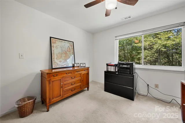 a room with furniture and large windows