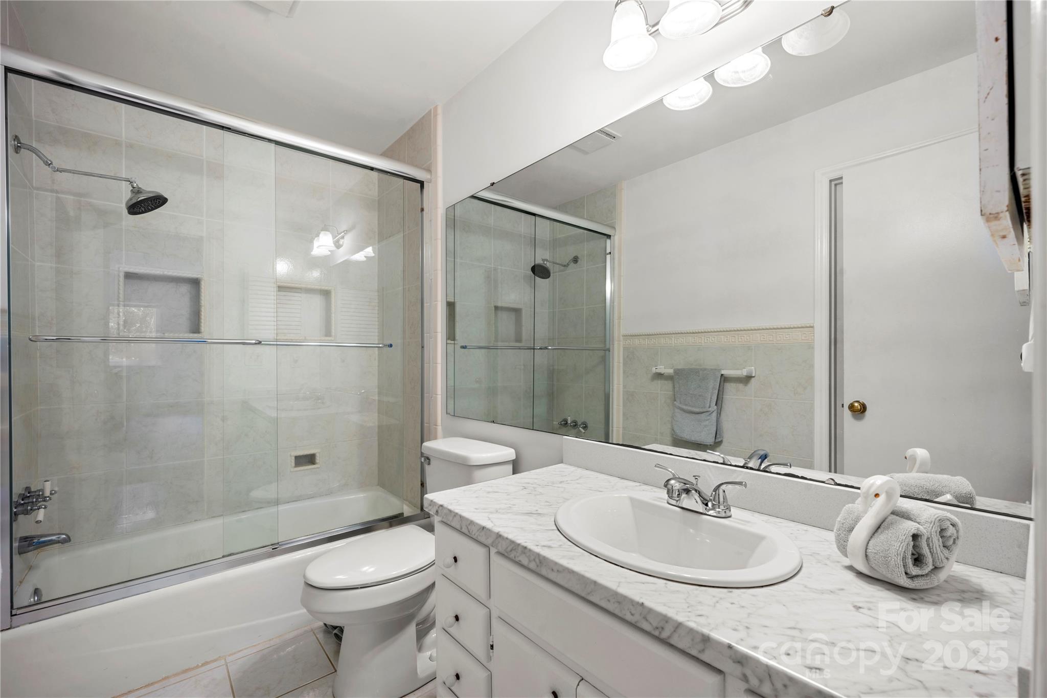 8928 St Croix Lane Charlotte, NC 28277 - Photo 26 of 37 a bathroom with a granite countertop sink a toilet and shower