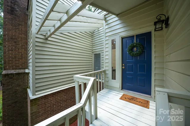 a balcony with wooden floor and furniture