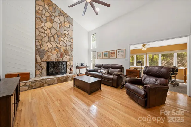 a living room with furniture wooden floor and a fireplace