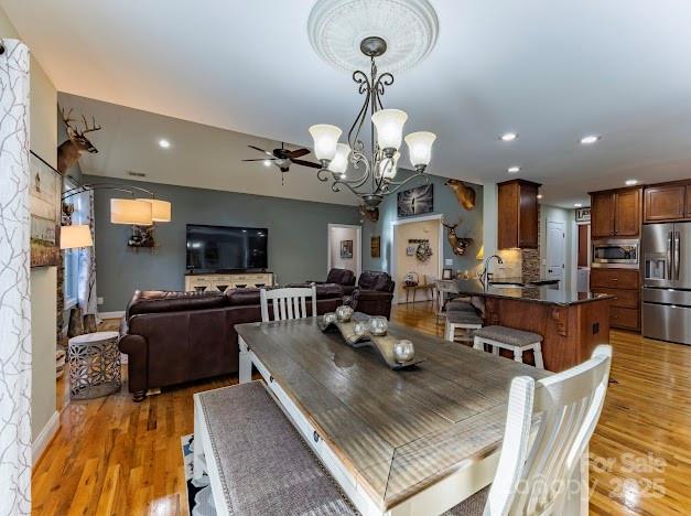 117 Maplewood Court Hudson, NC 28638 - Photo 13 of 48 a view of a dining room and livingroom with furniture wooden floor a chandelier