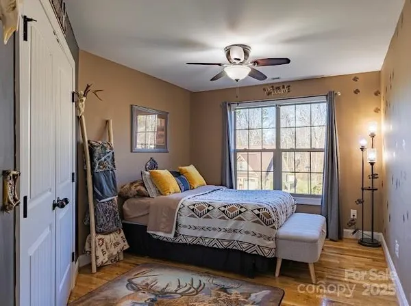 a bedroom with a bed and a chandelier