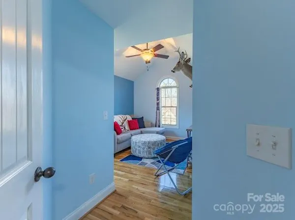 a living room with furniture a flat screen tv and a window