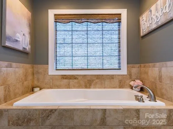 a bathroom with granite countertop double vanity and a mirror