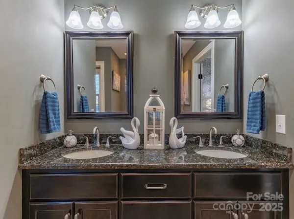 a spacious bathroom with a tub sink and mirror