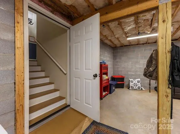 a view of staircase with lots of frames on wall