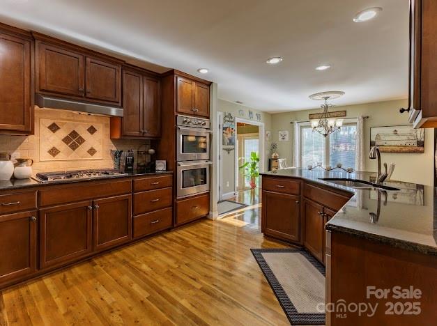 117 Maplewood Court Hudson, NC 28638 - Photo 9 of 48 a kitchen with stainless steel appliances granite countertop wooden cabinets a stove top oven a sink and dishwasher