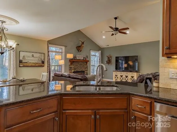 a kitchen with granite countertop stainless steel appliances and wooden cabinets