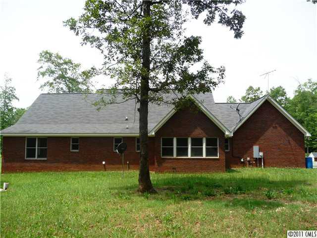4519 Wolf Pond Road Monroe, NC 28112 - Photo 13 of 16 a front view of a house with a garden