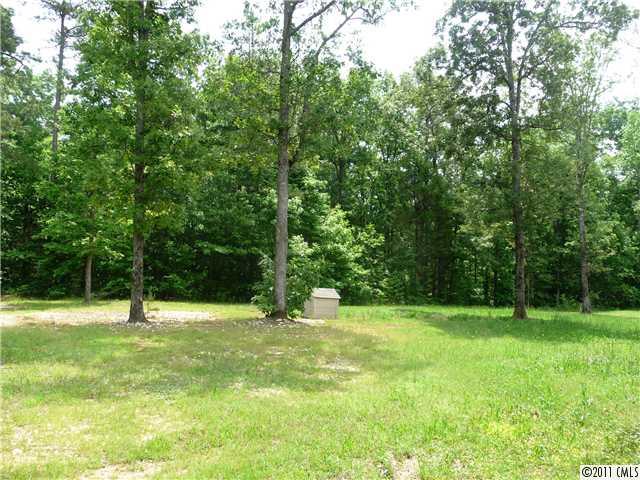 4519 Wolf Pond Road Monroe, NC 28112 - Photo 15 of 16 a view of green field with trees in the background
