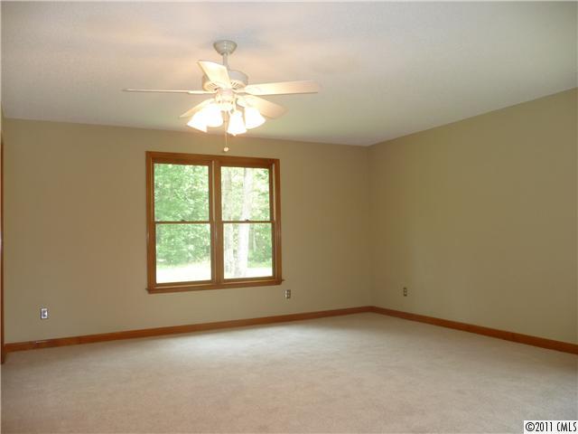 4519 Wolf Pond Road Monroe, NC 28112 - Photo 7 of 16 an empty room with a window and a fan