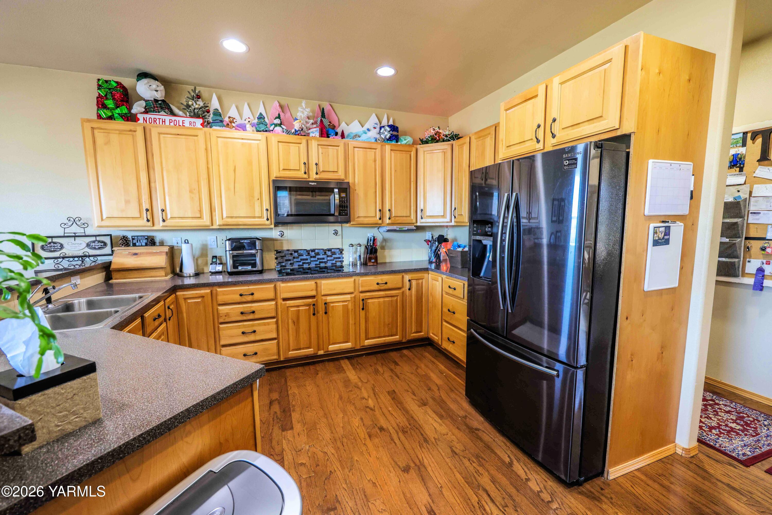224 Heysman Road Selah, WA 98942 - Photo 9 of 28 a kitchen with stainless steel appliances granite countertop a refrigerator a sink a stove a dining table and chairs
