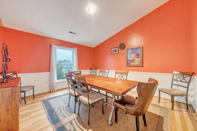 a dining room with furniture and wooden floor