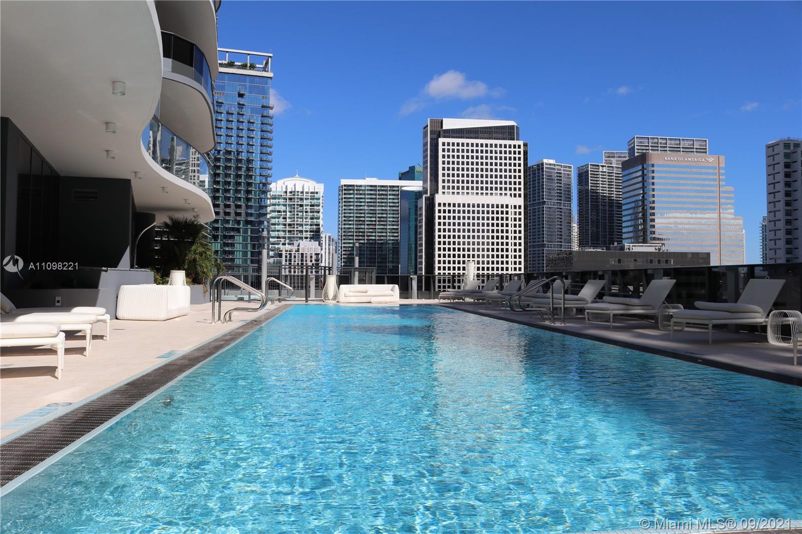 1000 Brickell Plaza, Unit 4907 Miami, FL 33131 - Photo 11 of 26 a swimming pool with outdoor seating and yard