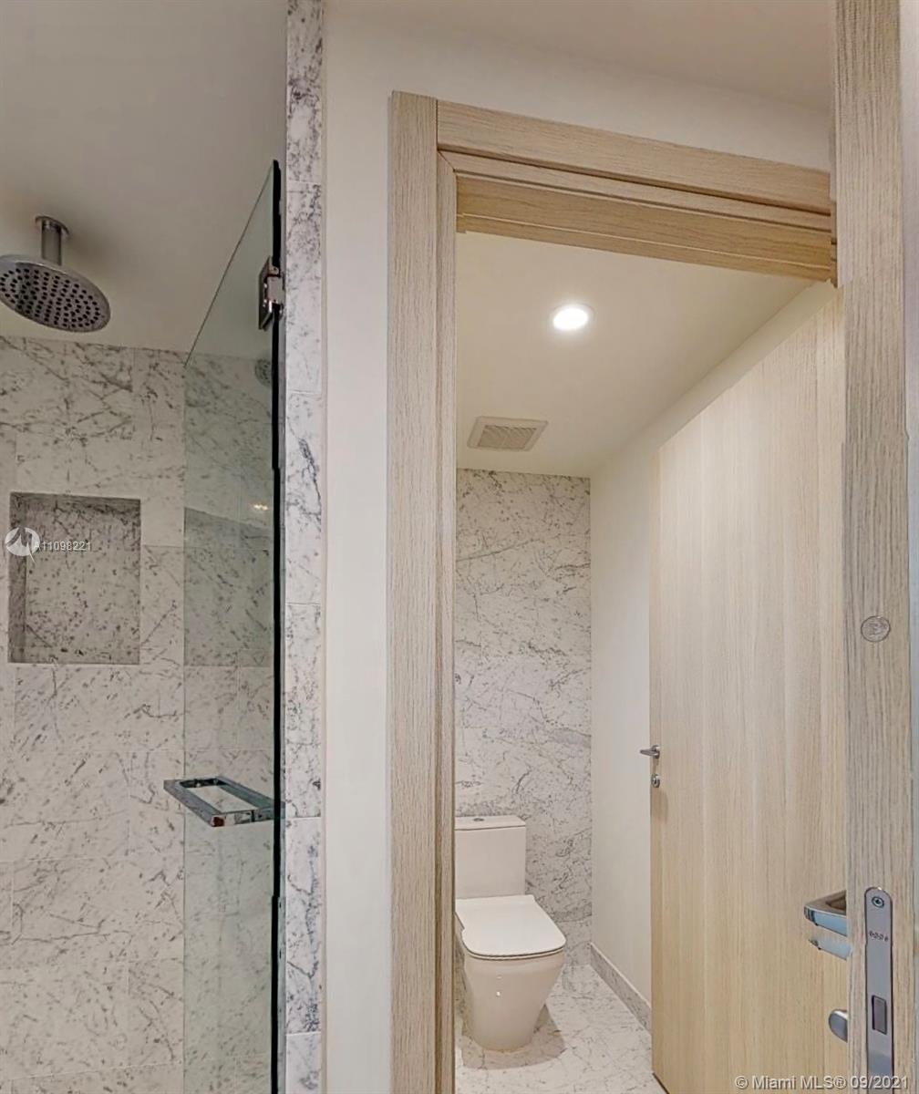 1000 Brickell Plaza, Unit 4907 Miami, FL 33131 - Photo 15 of 26 a bathroom with a granite countertop sink a toilet and shower