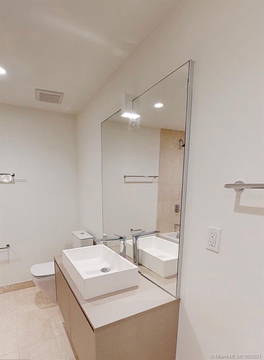 1000 Brickell Plaza, Unit 4907 Miami, FL 33131 - Photo 19 of 26 a bathroom with a sink a toilet and a mirror