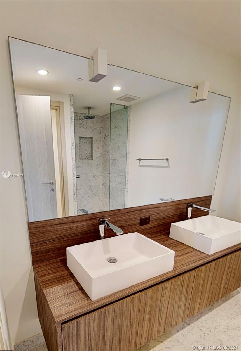 1000 Brickell Plaza, Unit 4907 Miami, FL 33131 - Photo 20 of 26 a bathroom with a sink and a mirror