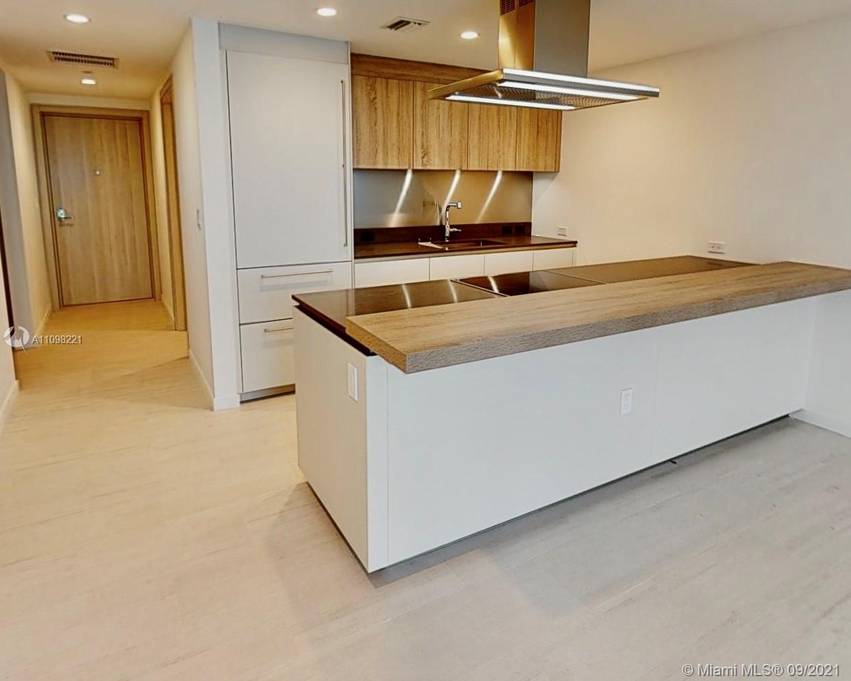1000 Brickell Plaza, Unit 4907 Miami, FL 33131 - Photo 24 of 26 a kitchen with a stove and a refrigerator
