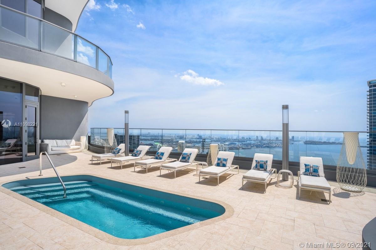 1000 Brickell Plaza, Unit 4907 Miami, FL 33131 - Photo 9 of 26 a view of a swimming pool and dinning table and chairs