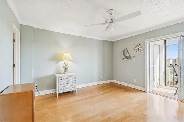 a view of a hallway with wooden floor and entryway