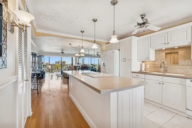 a open kitchen with stainless steel appliances granite countertop a stove and refrigerator