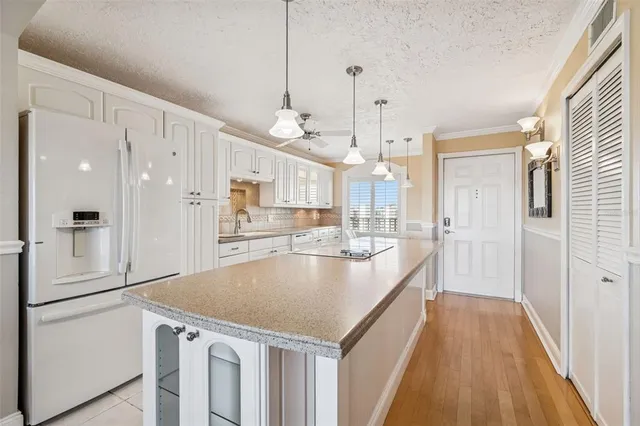 a open kitchen with a sink a center island a stove and a window