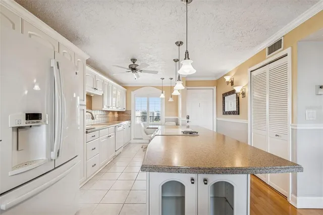 a kitchen with a stove a sink and a refrigerator