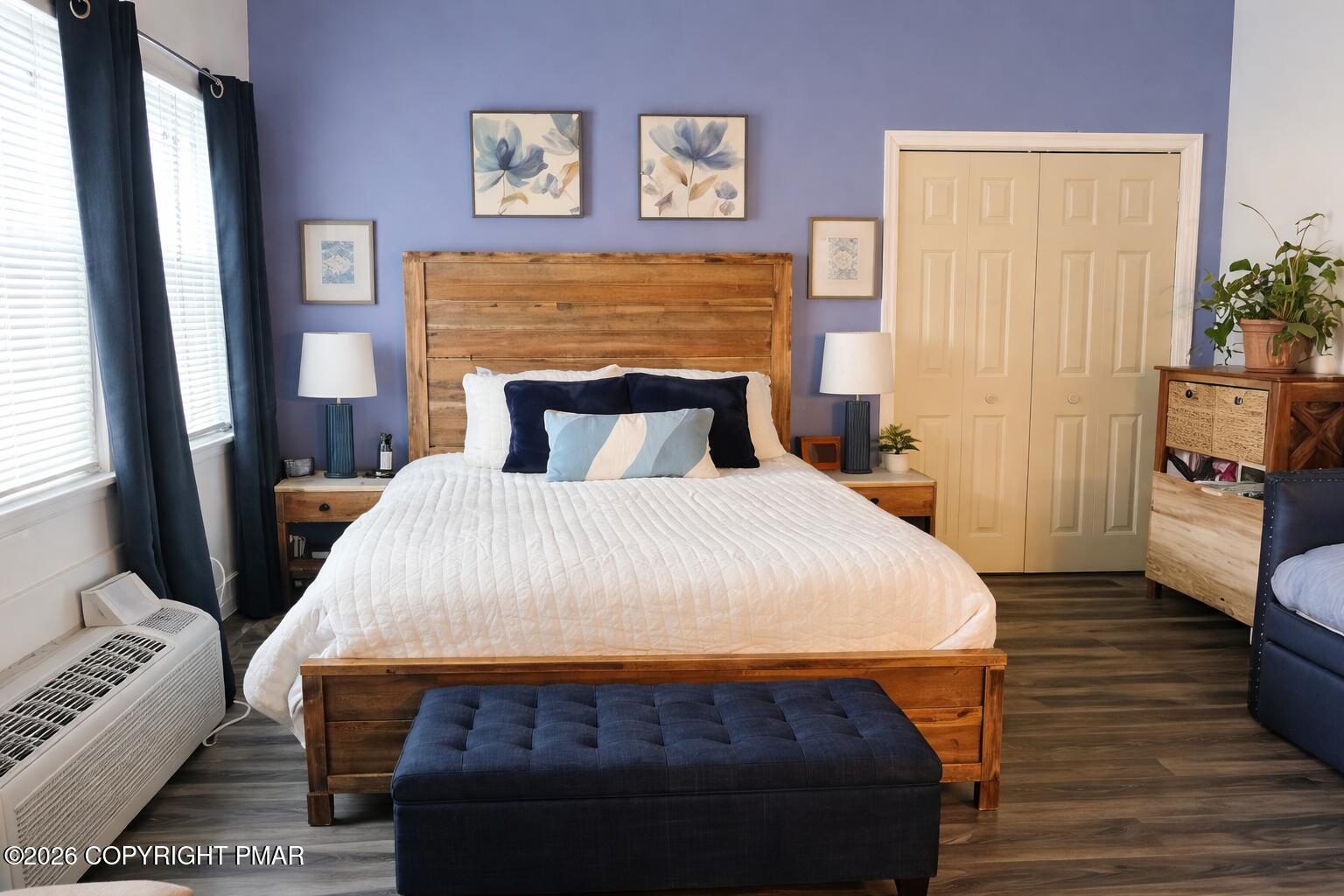 113 Condor Drive, Unit 30 Tamiment, PA 18371 - Photo 14 of 20 a bedroom with a bed and wooden floor