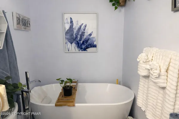 a white bath tub sitting in a bathroom