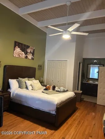 a bedroom with a bed and a couch