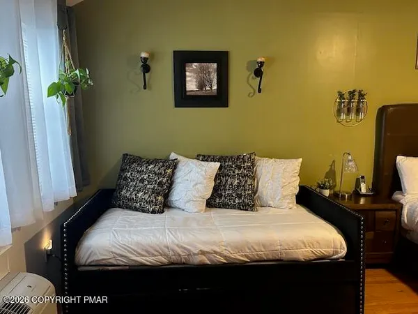 a bedroom with a bed and a potted plant
