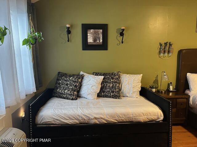113 Condor Drive, Unit 30 Tamiment, PA 18371 - Photo 19 of 20 a bedroom with a bed and a potted plant