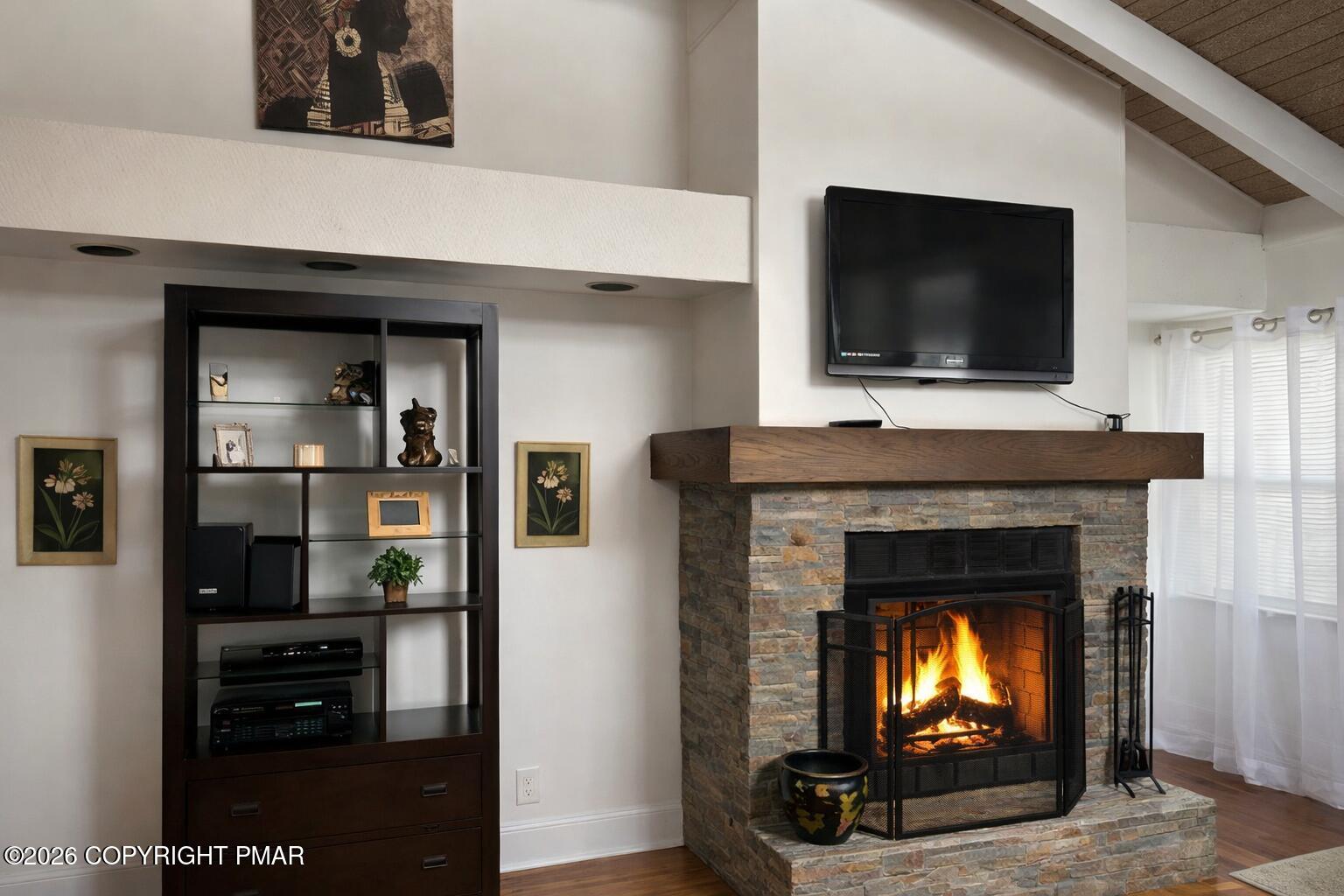 113 Condor Drive, Unit 30 Tamiment, PA 18371 - Photo 4 of 20 a living room with a fireplace and a flat screen tv