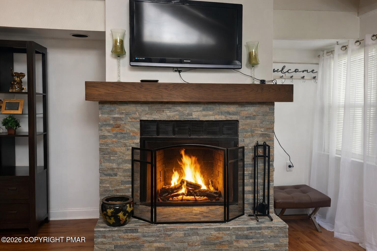 113 Condor Drive, Unit 30 Tamiment, PA 18371 - Photo 5 of 20 a living room with a fireplace and a flat screen tv