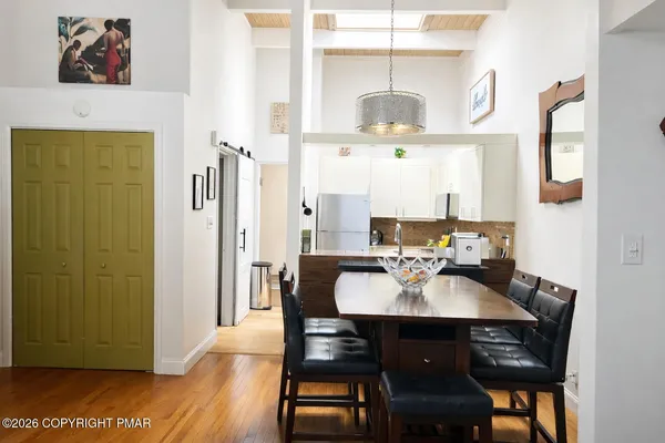 a view of a dining room with furniture and wooden floor