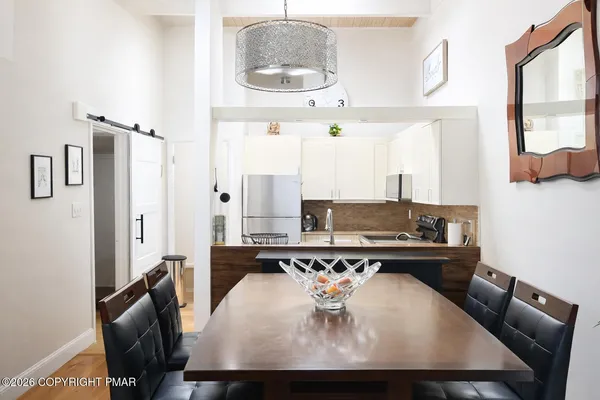 a dining room with furniture and wooden floor