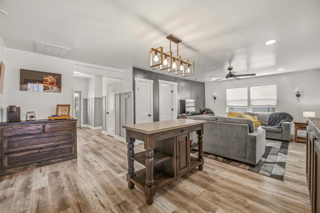 412 North Kirk Street Hico, TX 76457 - Photo 12 of 25 a view of kitchen island with furniture and wooden floor