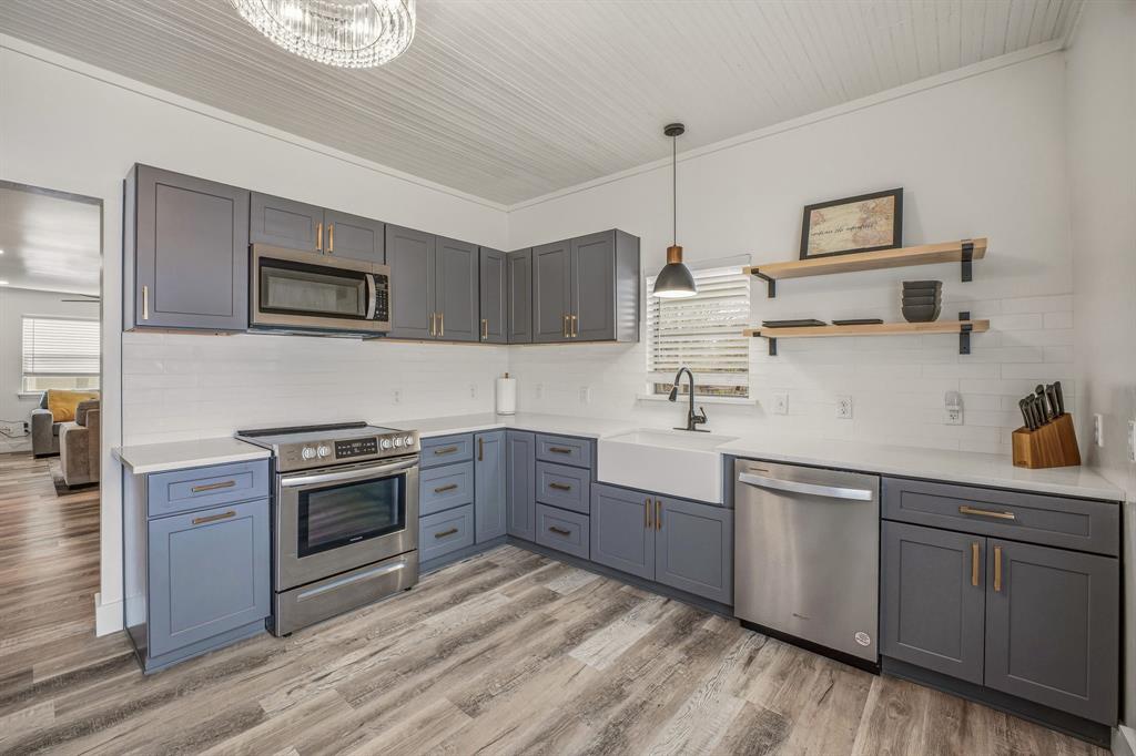 412 North Kirk Street Hico, TX 76457 - Photo 14 of 25 a kitchen with sink cabinets and stainless steel appliances