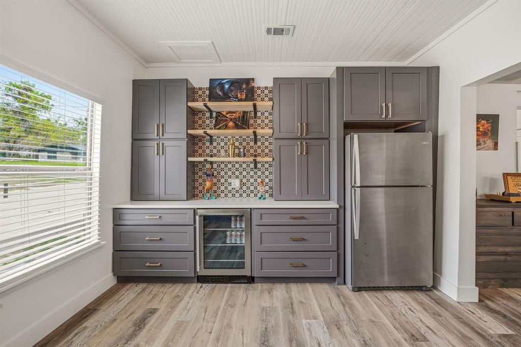 412 North Kirk Street Hico, TX 76457 - Photo 15 of 25 a kitchen with stainless steel appliances wooden floor and window