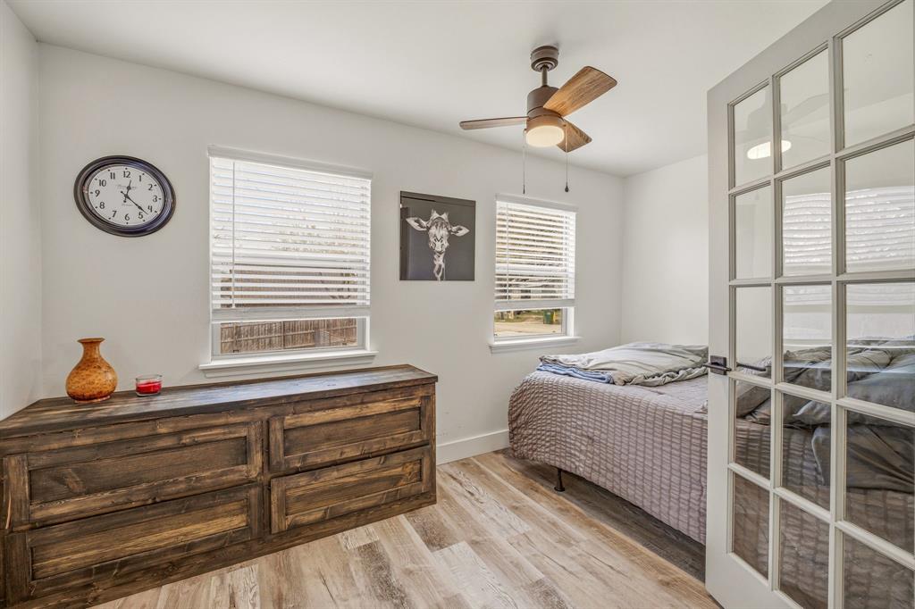 412 North Kirk Street Hico, TX 76457 - Photo 19 of 25 a bedroom with a bed and a chandelier