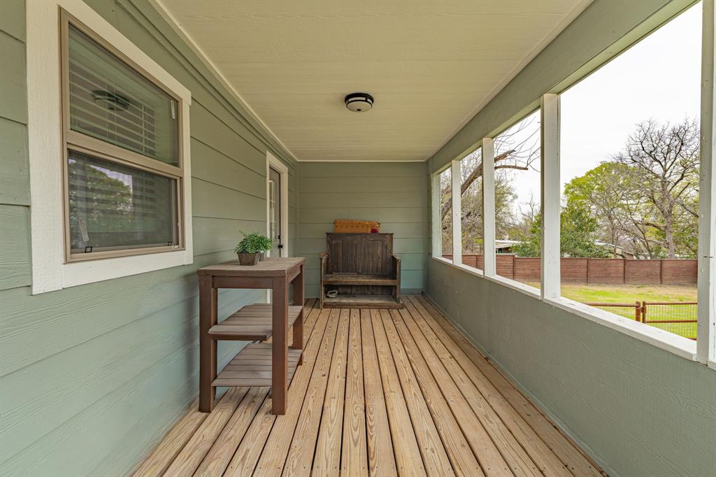 412 North Kirk Street Hico, TX 76457 - Photo 20 of 25 a view of a balcony with chair and wooden floor