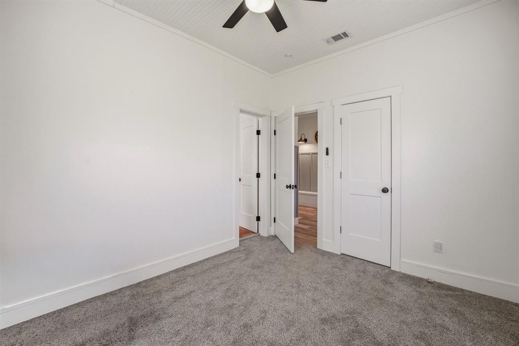 412 North Kirk Street Hico, TX 76457 - Photo 7 of 25 an empty room with chandelier fan