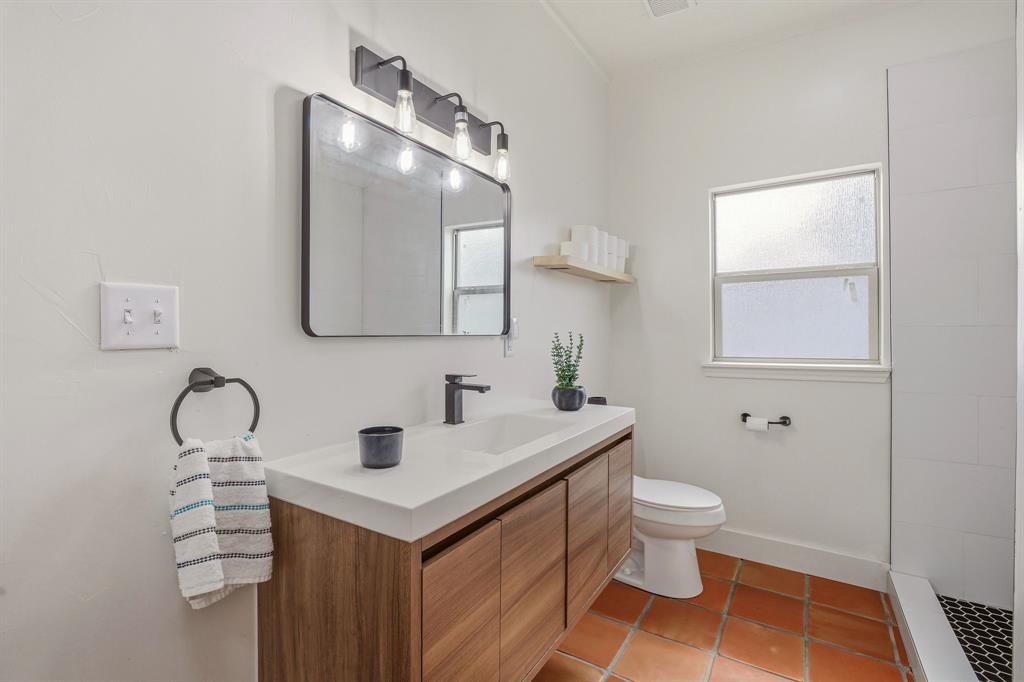412 North Kirk Street Hico, TX 76457 - Photo 8 of 25 a bathroom with a sink toilet and mirror