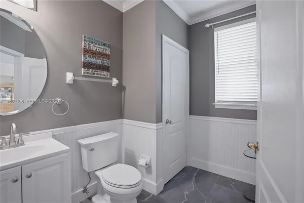 a white toilet sitting next to a bathroom sink
