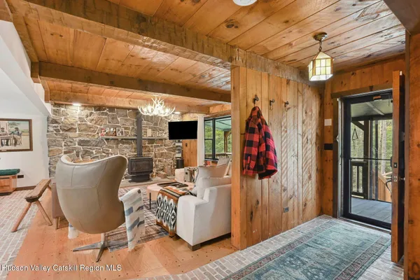a living room with furniture a flat screen tv and kitchen view