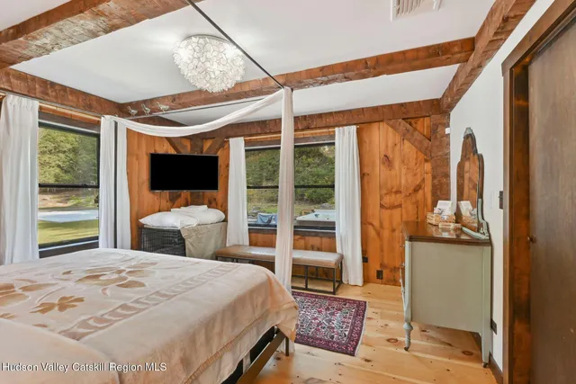 a view of a swimming pool and lounge chairs in back yard of the house
